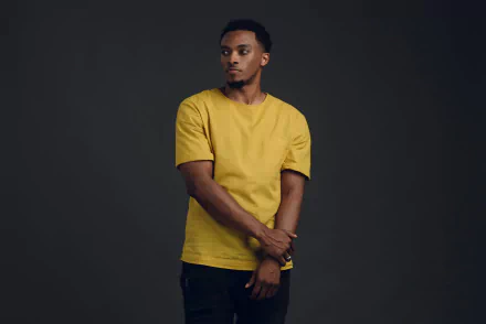 Man in yellow shirt posing for a HD desktop wallpaper and background.