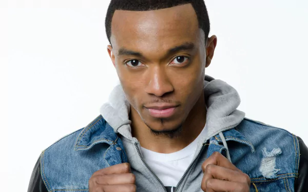 HD wallpaper featuring a man in a denim jacket and gray hoodie against a white background.