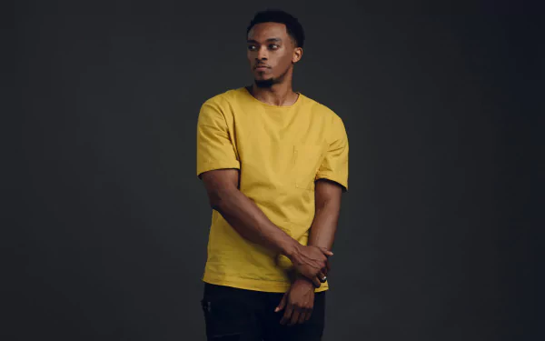 Man in yellow shirt posing for a HD desktop wallpaper and background.