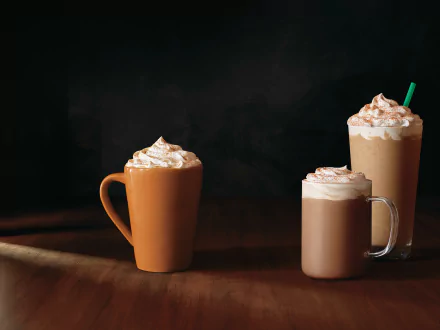 HD desktop wallpaper featuring a mug and two glasses of coffee with whipped cream on a dark background.