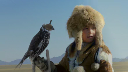  A Young Mongolian Girl with her Hunting Bird in the Late Afternoon by Les Pearce