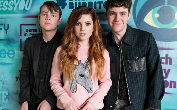 HD desktop wallpaper featuring three members of Echosmith standing together against a vibrant, graffiti-style background.