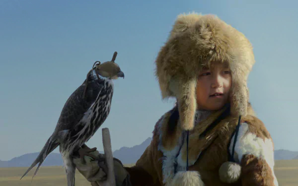  A Young Mongolian Girl with her Hunting Bird in the Late Afternoon by Les Pearce