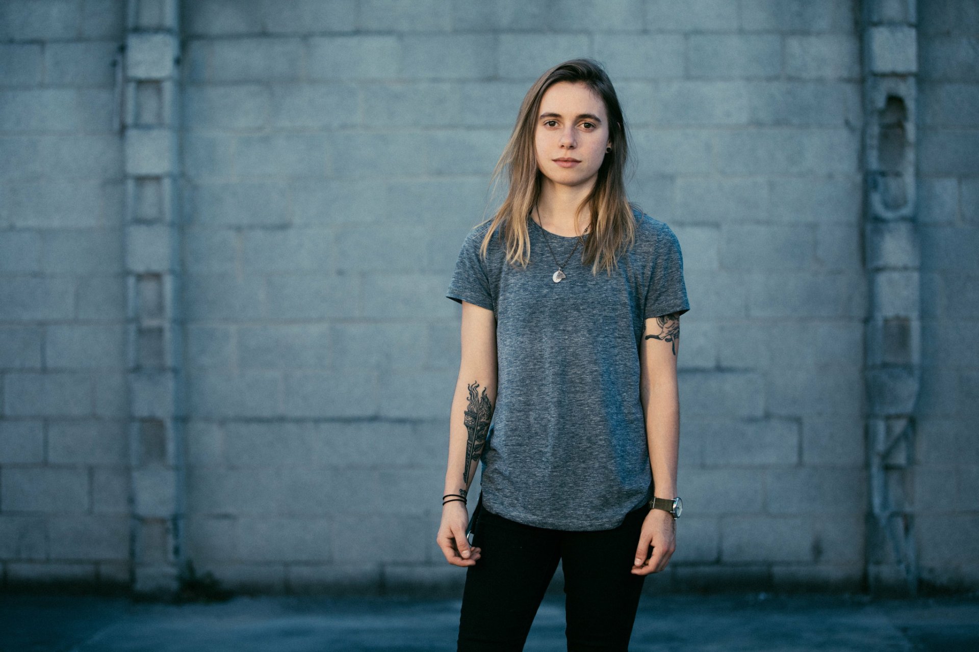HD desktop wallpaper of a person standing in front of a grey wall, tagged with Julien Baker.