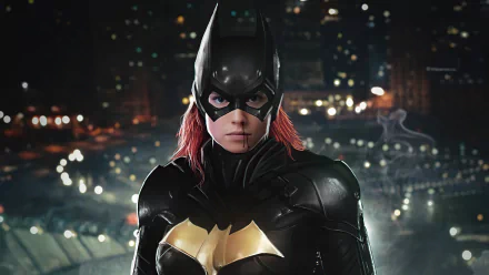 DC Comics Batgirl in an armored black-and-gold suit with red hair under the cowl, facing forward against a lit city skyline at night — 4K Ultra HD PC desktop wallpaper