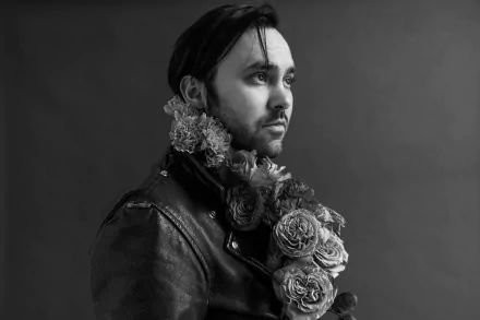 HD desktop wallpaper featuring a monochrome portrait of an individual with floral adornments, associated with Shakey Graves.