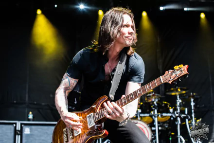 Guitarist performing on stage HD wallpaper for desktop background.