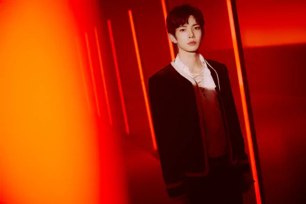 5K Ultra HD music desktop wallpaper: lone figure in a deep red-lit corridor, moody stage atmosphere. Tag: ENHYPEN.