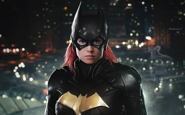 DC Comics Batgirl in an armored black-and-gold suit with red hair under the cowl, facing forward against a lit city skyline at night — 4K Ultra HD PC desktop wallpaper