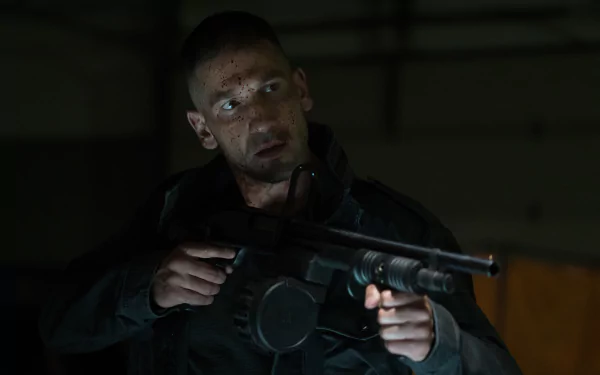 2K Quad HD PC wallpaper of a TV show vigilante from Daredevil: a rugged man holding a rifle in a dim, shadowed interior.