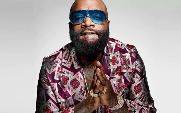 HD desktop wallpaper featuring a person with sunglasses in a patterned jacket against a light background.