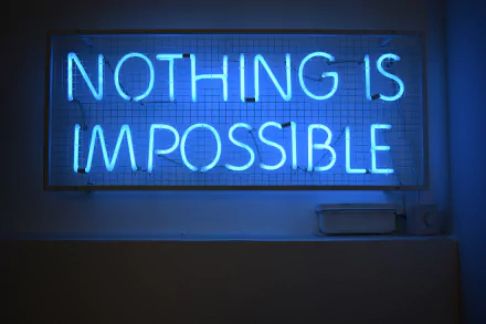 A vibrant blue neon sign displaying the motivational phrase NOTHING IS IMPOSSIBLE, captured as a 4K Ultra HD artistic PC desktop wallpaper.