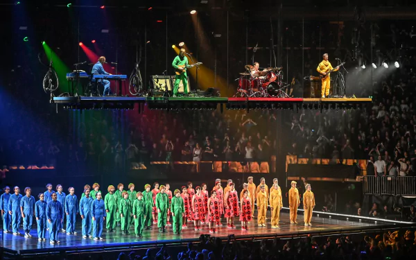 HD wallpaper of Phish band performing live on stage with colorful lighting and a vibrant audience.