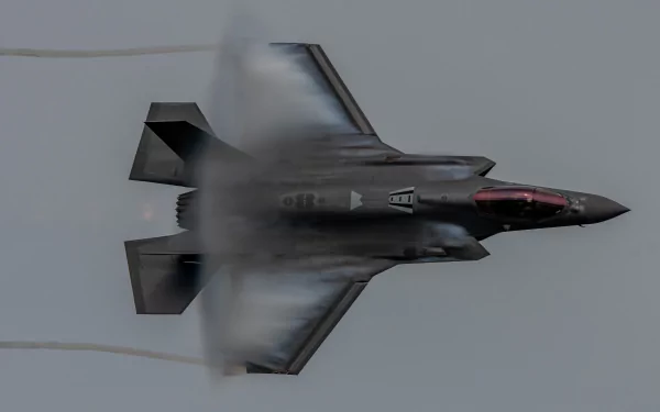Lockheed Martin F-35 Lightning II jet fighter warplane captured in dynamic flight, creating vapor cone effects, showcased in 4K Ultra HD with military aircraft detail.