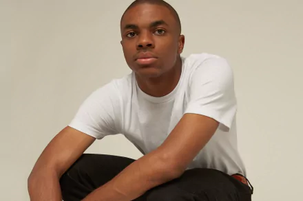 A person in a white shirt posing for an HD desktop wallpaper with a neutral background.