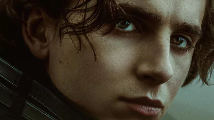 Close-up HD desktop wallpaper of Timothée Chalamet from the movie Dune (2021), showcasing his intense gaze and detailed facial features.
