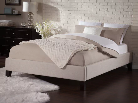 HD desktop wallpaper featuring a stylish bed with beige bedding in an elegant room with a brick wall background.