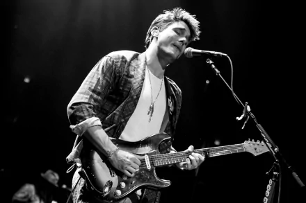 Guitarist performing live in black and white HD desktop wallpaper.