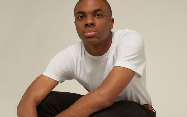 A person in a white shirt posing for an HD desktop wallpaper with a neutral background.