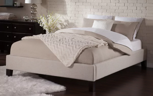 HD desktop wallpaper featuring a stylish bed with beige bedding in an elegant room with a brick wall background.