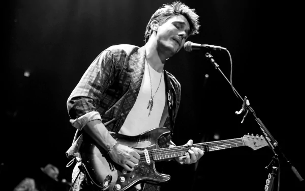 Guitarist performing live in black and white HD desktop wallpaper.