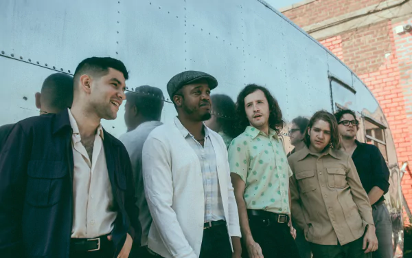 HD desktop wallpaper featuring the band members of Durand Jones & The Indications standing together against an urban backdrop for music fans to use as a background.