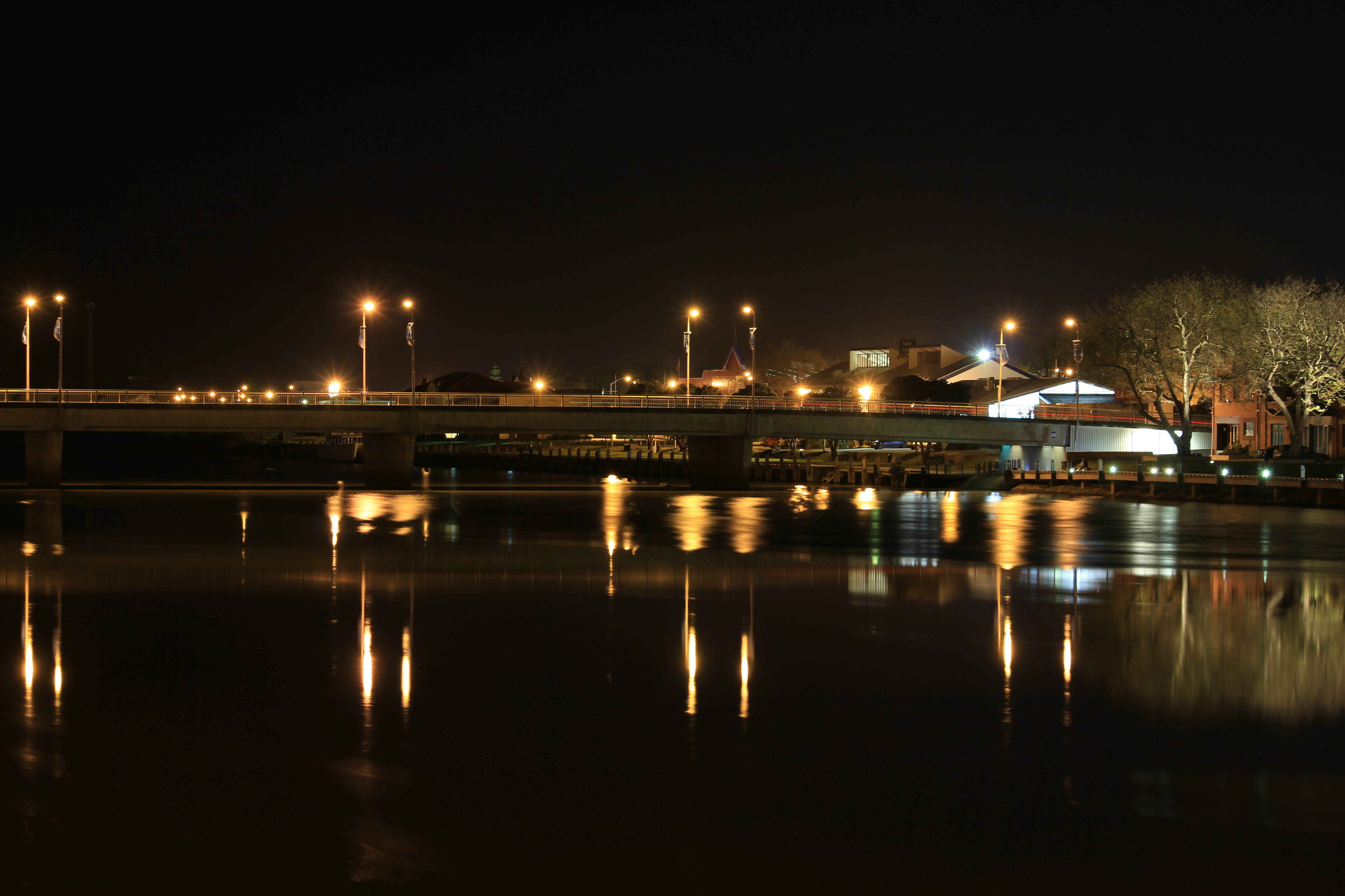 Nighttime scenery of Wanganui River, captured by Blizzardnz. Serene river reflecting soft light.