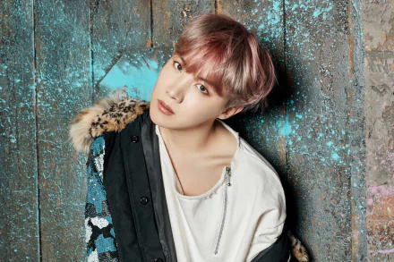 HD desktop wallpaper featuring J-Hope (Jung Hoseok) from BTS, showcasing the K-pop singer in a stylish jacket against a textured, blue-splattered background.