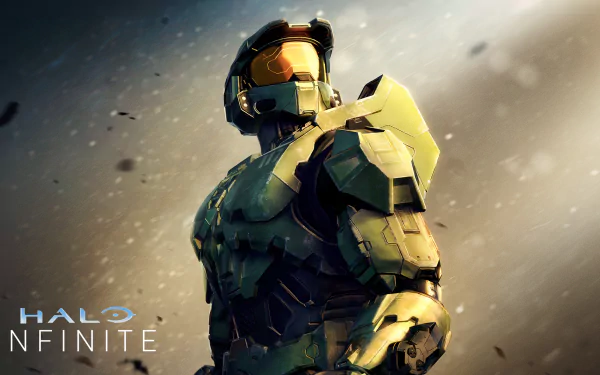 HD desktop wallpaper of a Halo Infinite Spartan soldier looking over the shoulder amidst a dust speckled background.