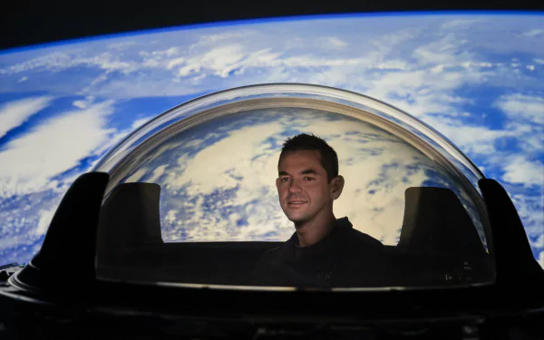Person smiling inside Inspiration4 spacecraft with stunning view of Earth from space as HD desktop wallpaper background.