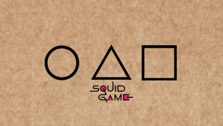 HD PC desktop wallpaper featuring the iconic circle, triangle, and square symbols from the TV show Squid Game, set against a textured brown background.
