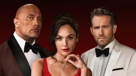 HD desktop wallpaper poster for the movie Red Notice showing three characters: a woman in a red gown centered between two men in tuxedos against a deep red background.
