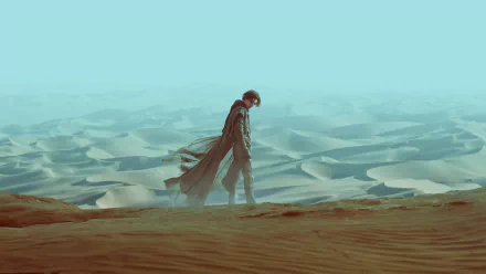 Timothée Chalamet as Paul Atreides walking across vast desert dunes in a 4K Ultra HD wallpaper from the 2021 movie Dune.