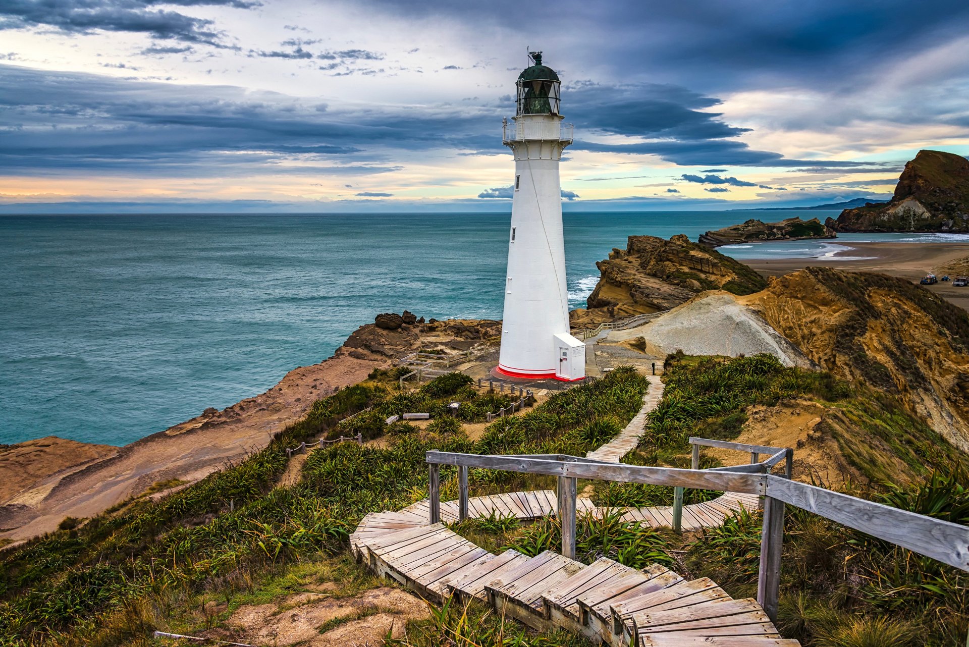 4K Ultra HD image of a man-made lighthouse on the rocky coast of New Zealand under a cloudy sky, captured as a PC desktop wallpaper and background.