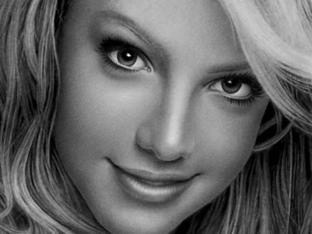Close-up black-and-white HD desktop wallpaper of Britney Spears, capturing her expressive eyes and subtle smile in a music-themed portrait.
