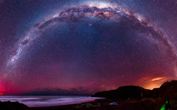A breathtaking 8K Ultra HD Sci-Fi style night sky showcasing the Milky Way arching over a dark coastal landscape, filled with countless shimmering stars.