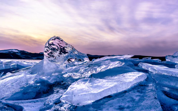 Iceland’s icy landscape captured in stunning 4K Ultra HD, showcasing translucent ice formations under a soft pastel sky in a natural, pristine setting.