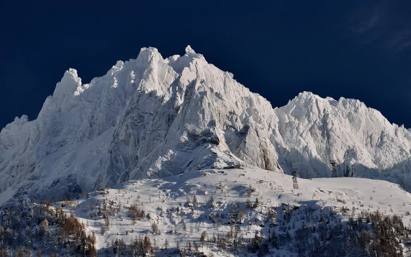 Snow-covered mountain peak under a deep blue sky, showcasing pristine nature in this HD PC desktop wallpaper and background.