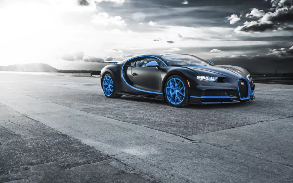 A sleek Bugatti Chiron supercar with blue accents and wheels parked on an open concrete surface under a dramatic sky, captured in 8K Ultra HD for PC desktop wallpaper.