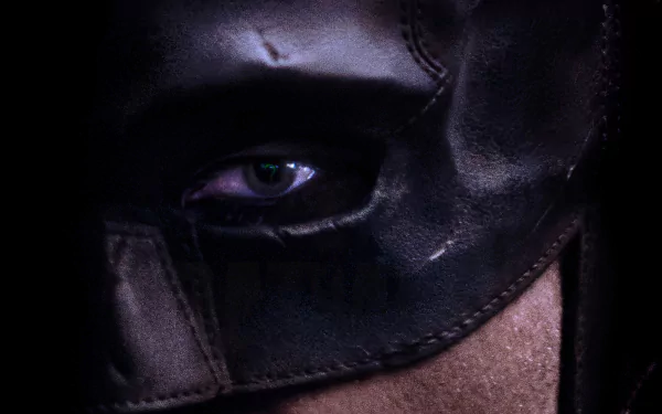 Close-up, detailed 4K Ultra HD PC desktop wallpaper of The Batman's masked face from the movie, highlighting his intense eye and textured leather mask.