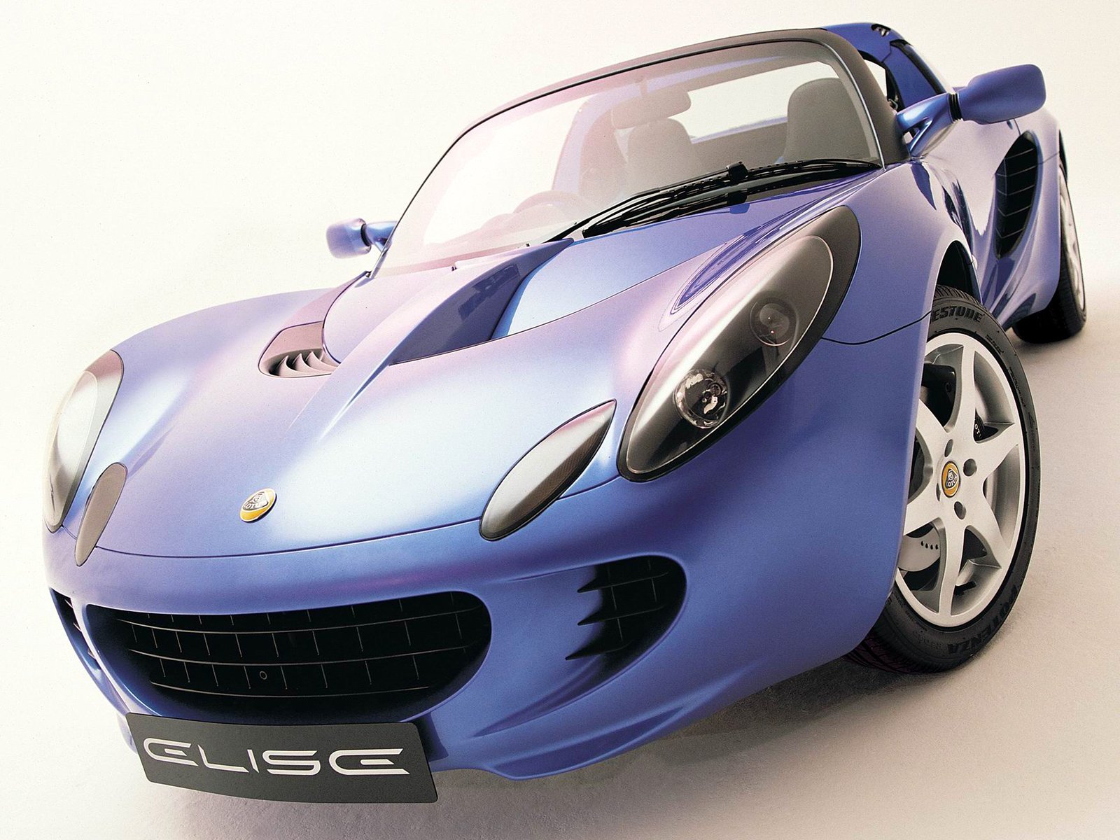 HD PC desktop wallpaper and background showing a metallic blue Lotus Elise sports vehicle angled low with glossy finish, visible headlights and front grille.