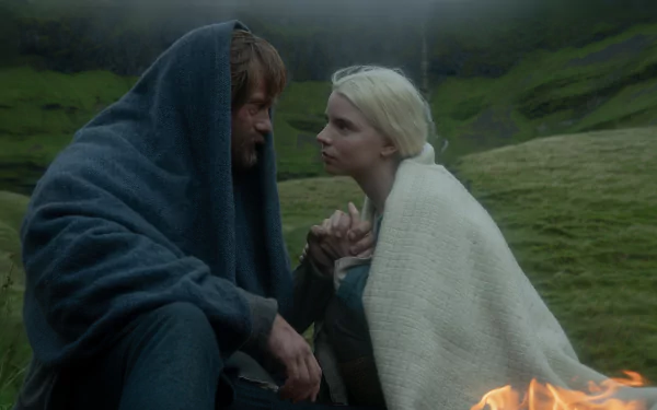 4K Ultra HD wallpaper featuring Alexander Skarsgård and Anya Taylor-Joy in a scene from the movie The Northman, set against a misty, green hillside background.