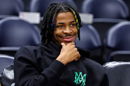 HD PC desktop wallpaper featuring basketball player Ja Morant with colorful braided hair, smiling and seated in a sports arena.