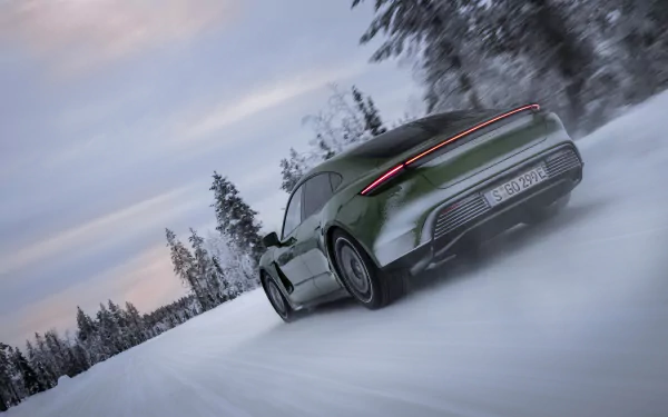 Green Taycan 4S driving on snow