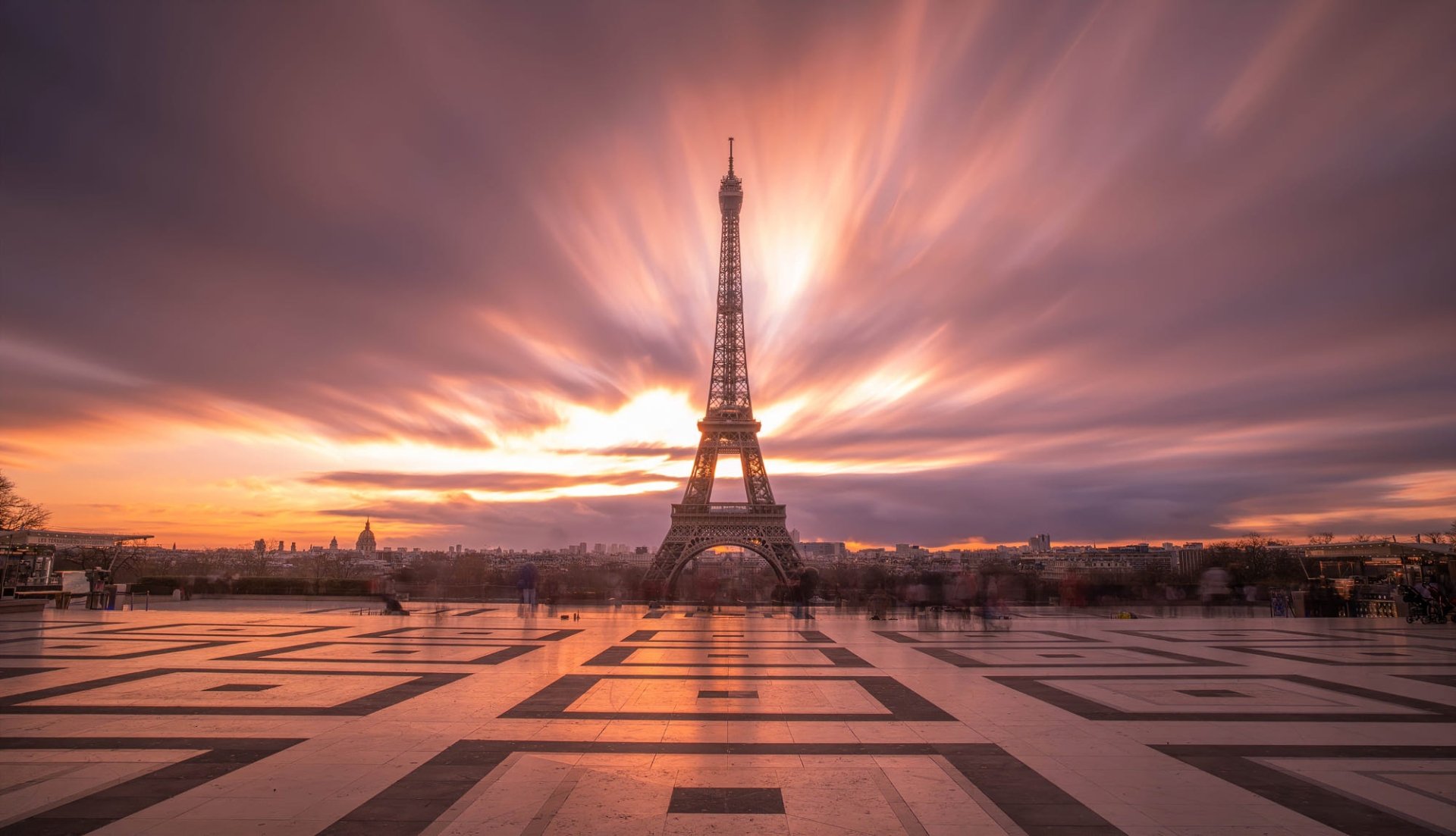 HD PC desktop wallpaper of the Eiffel Tower in France: the man-made landmark framed by a dramatic sunrise and reflective tiled foreground.