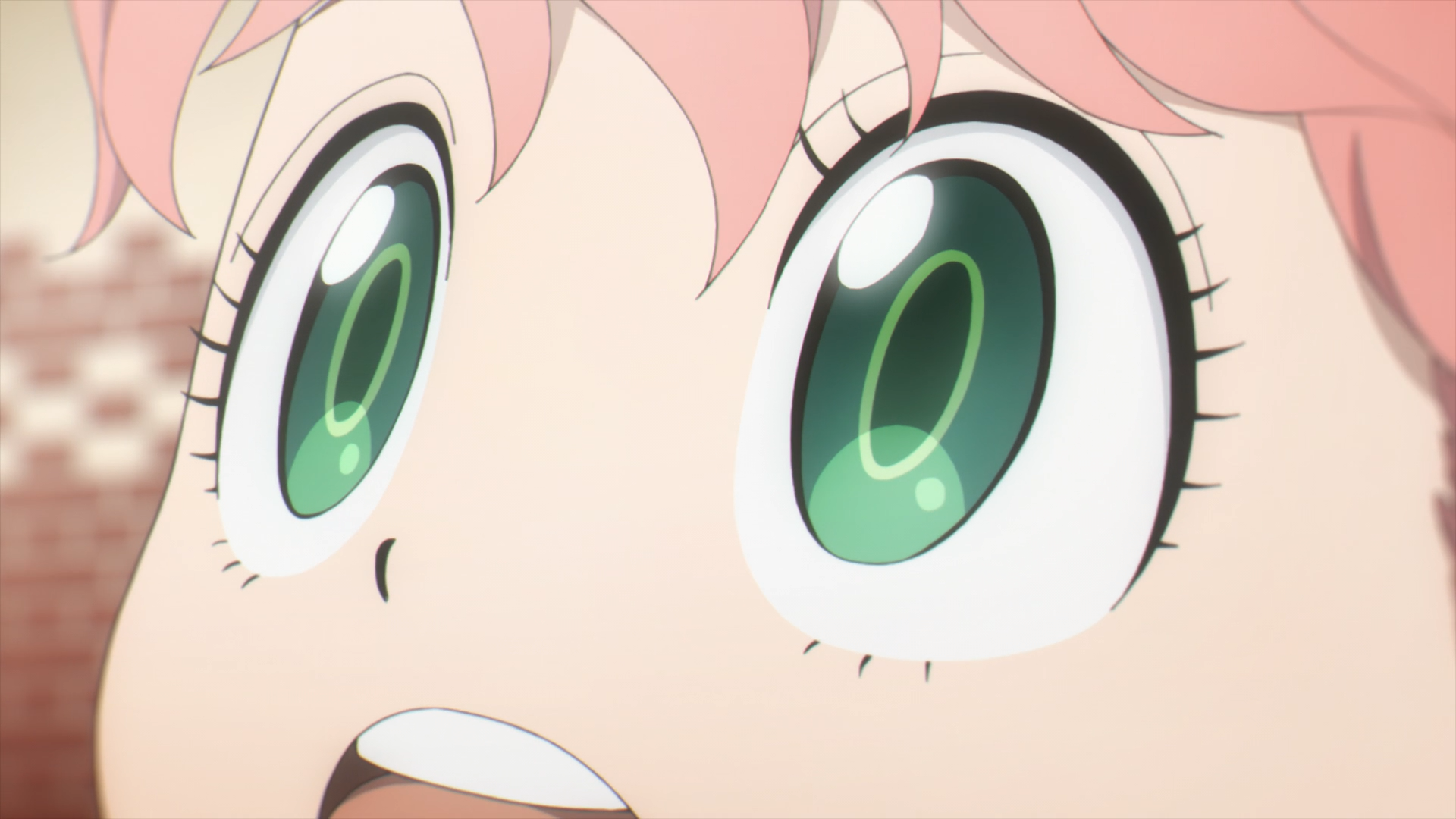 Close-up HD PC desktop wallpaper of Anya Forger from Spy x Family, her wide green eyes and excited expression filling the frame.