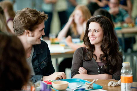 Edward Cullen and Bella Swan smile across a cafeteria table in a scene from The Twilight Saga: Eclipse — 2K Quad HD PC desktop wallpaper.