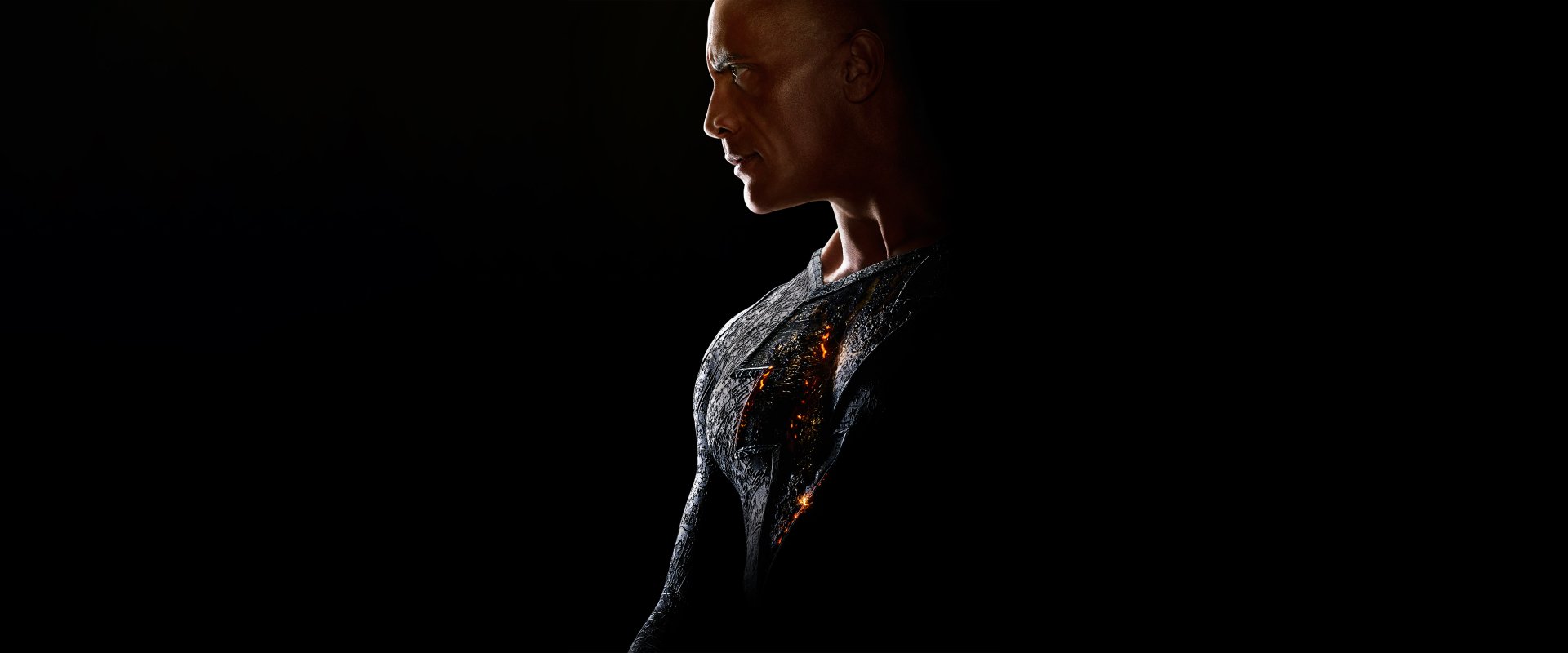 Dwayne Johnson as Black Adam in a dramatic 8K Ultra HD movie wallpaper, showcasing intense detail and lighting on the superhero's suit against a dark background.