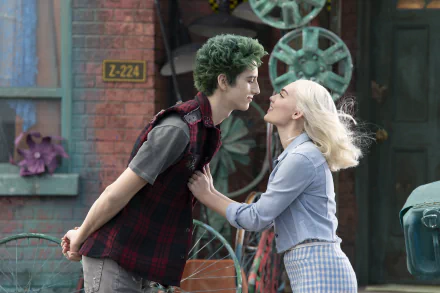 Movie Zombies 3 2K Quad HD PC desktop wallpaper, two young characters: green-haired male and blonde female lean in smiling against an industrial outdoor set.