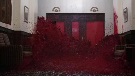 HD PC desktop wallpaper featuring a dramatic scene from the movie The Shining with a flood of blood bursting through a hotel corridor.